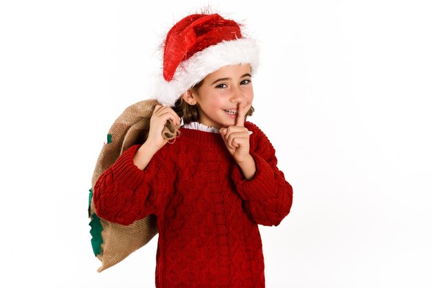 Immagini Natale Da Ridere.Bambina Vestita Da Babbo Natale Ridere E Chiede Il Silenzio Con Un Sacco Marrone Foto Gratis