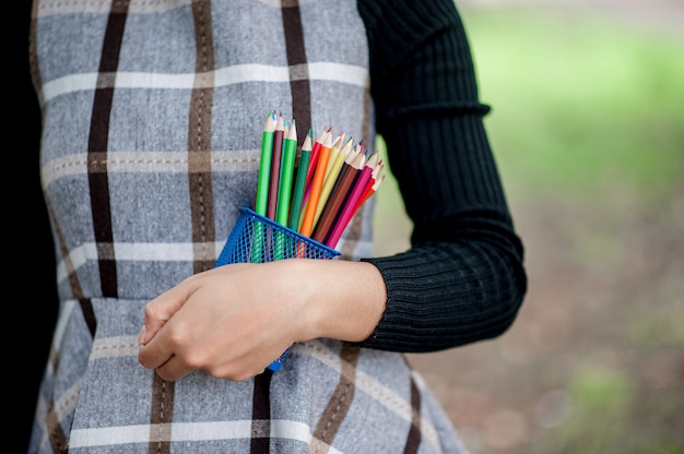Immagini di mano e matita, colore di sfondo verde concetto di educazione Foto Premium