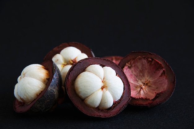 Mangosteen frutti popolari tailandesi - un frutto tropicale con segmenti bianchi succosi e succosi di carne all'interno di una spessa crosta rossiccia-marrone. Foto Gratuite