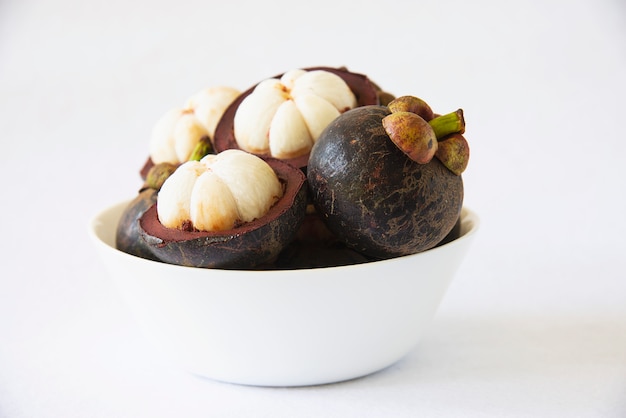 Mangosteen frutti popolari tailandesi - un frutto tropicale con segmenti bianchi succosi e succosi di carne all'interno di una spessa crosta rossiccia-marrone. Foto Gratuite