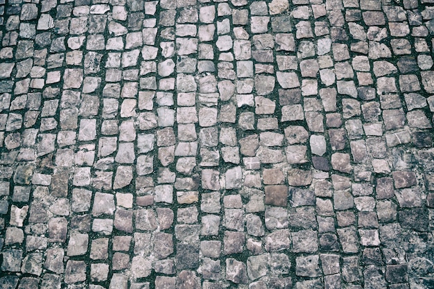 Pavimentazione lapidata di ciottoli di granito. Foto Premium
