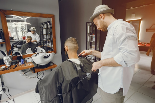 Un uomo taglia i capelli in un negozio di barbiere. | Foto ...