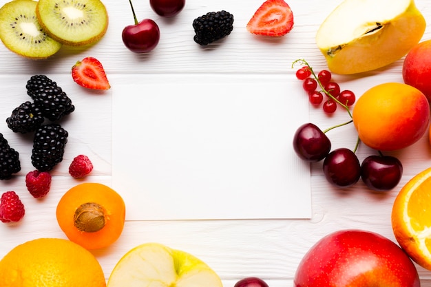 Apartamento-leigo de frutas frescas e frutas com papel Foto gratuita