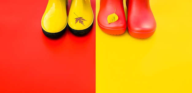 As botas de chuva das mulheres brilhantes em fundos coloridos com voado saem nas pontas. Foto Premium