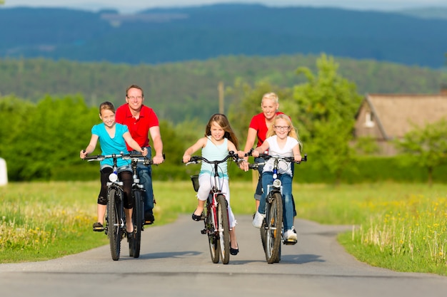 Família com filhos, andar de bicicleta no verão com bicicletas Foto Premium