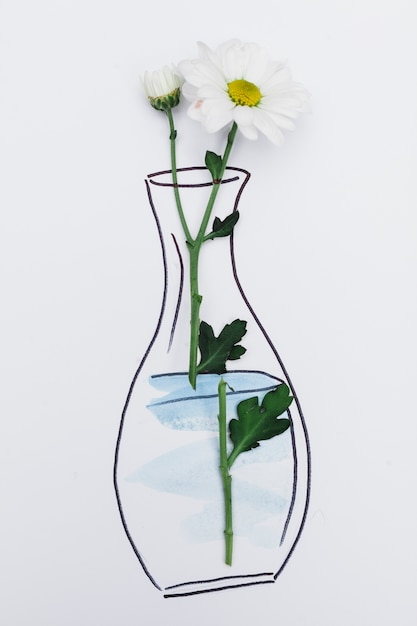 Flor fresca colocada no papel com vaso desenhado Foto gratuita