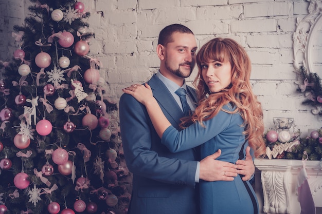 Homem mulher, em, sala, com, árvore natal, e, lareira Foto Premium