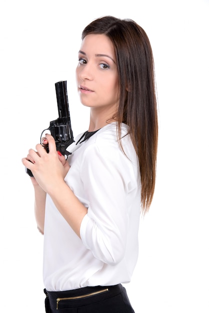 Jovem e linda mulher segurando uma arma Foto Premium