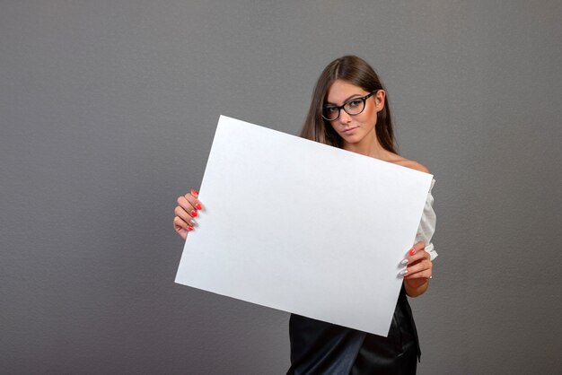 Linda mulher segurando um cartaz em branco Foto Premium