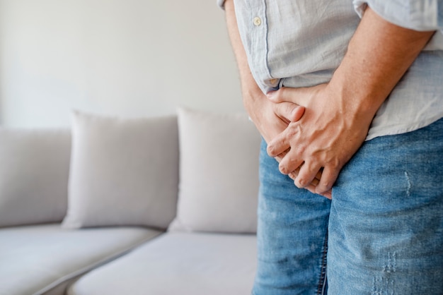 Macho sofrendo com dor no sistema urogenital. doença para homens. Foto Premium