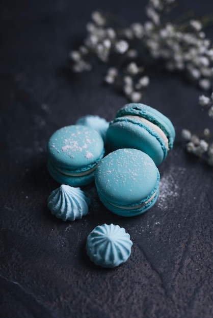 Merengue com empilhados de macaroon azul no plano de fundo texturizado Foto gratuita