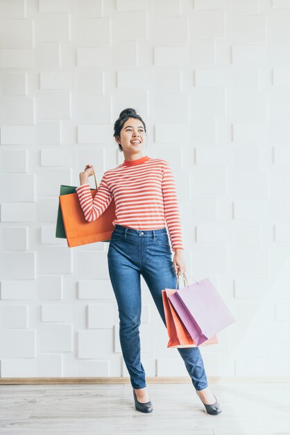Mulher asiática, segurando sacolas de compras Foto Premium