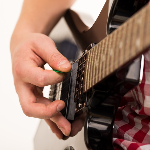 Música, close-up. jovem músico segurando a guitarra electro Foto gratuita