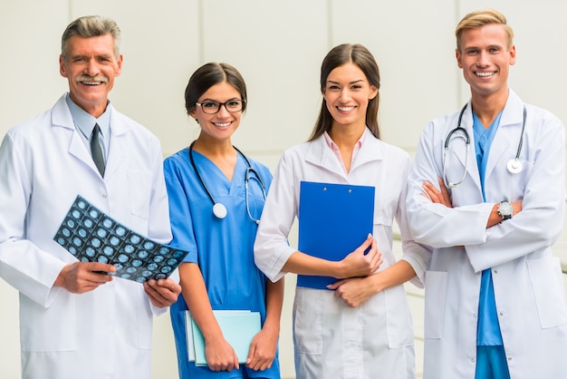 Os médicos estão de pé e sorrindo. Foto Premium
