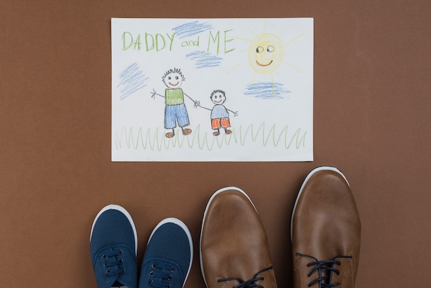 Papai e eu desenhando com sapatos homem e criança Foto gratuita