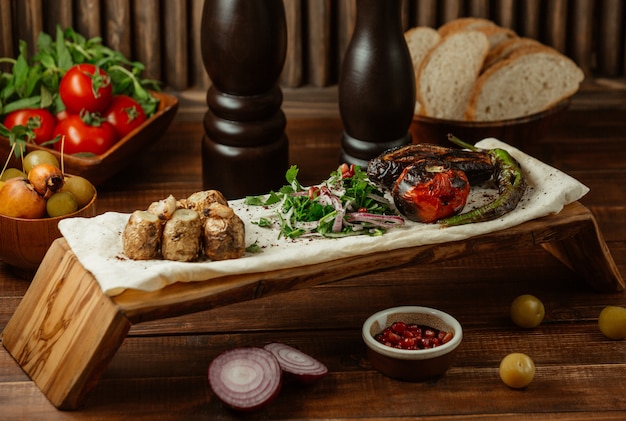 Pedaços pequenos de carne assada com salada verde em um pedaço de lavash, yukha Foto gratuita