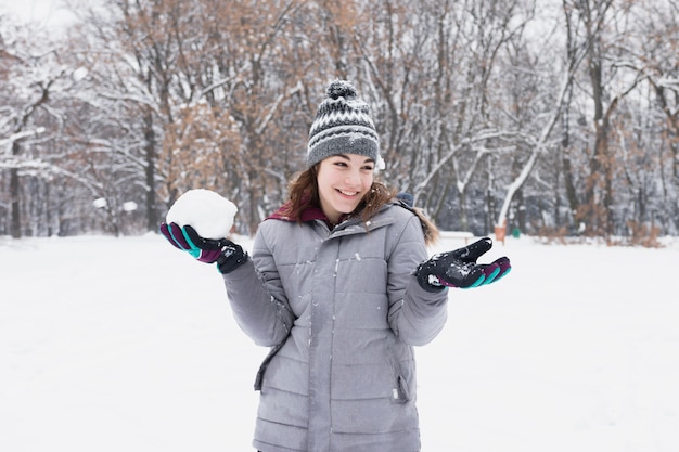 Retrato, de, um, bonito, menina sorridente, segurando, snowball, em, floresta Foto gratuita