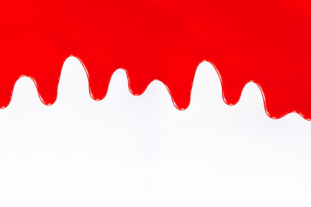 Tinta vermelha pingando sobre um branco. Foto Premium