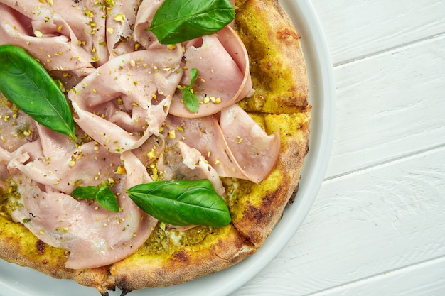 Appetitliche hausgemachte pizza mit mortadella-wurst, pistazien ...