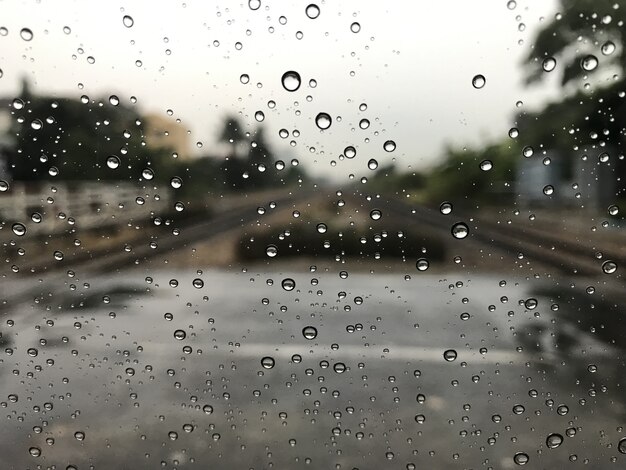 Blured hintergrund mit regen fällt auf glas und autos auf der eisenbahn Premium Fotos