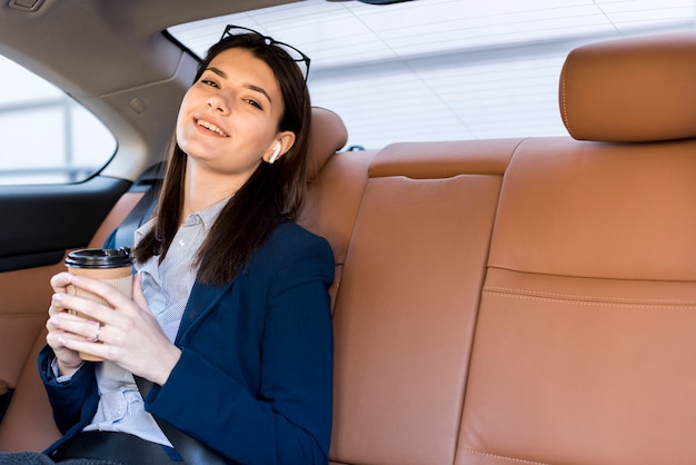 Brunettegeschäftsfrau, die innerhalb eines autos aufwirft Kostenlose Fotos