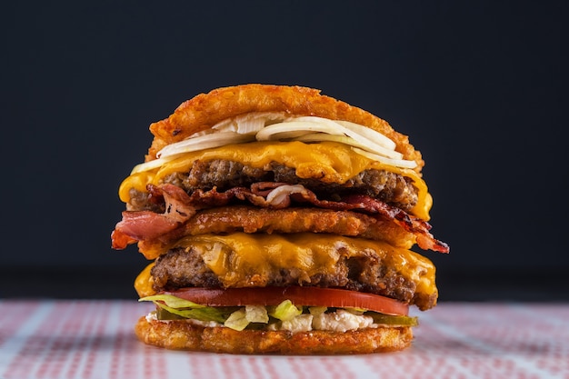 Doppelburger mit kartoffelpuffer mit speck, rindfleisch, tomate und ...