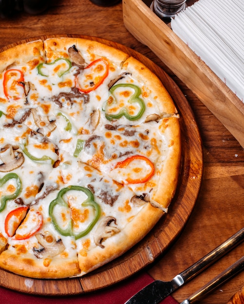 Draufsicht der pizza gefüllt mit tomaten bunte paprika-salami und ...