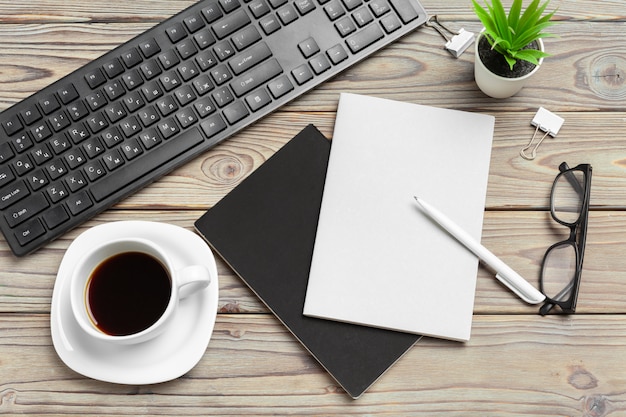 Draufsicht des hölzernen desktops mit gläsern und briefpapierartikeln nah oben. attrappe, lehrmodell, simulation Premium Fotos