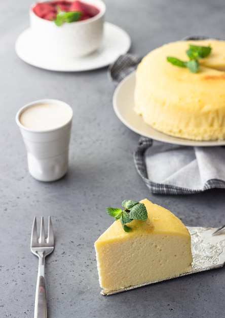 Ein stück japanischer baumwollkäsekuchen mit minze und erdbeere. Premium Fotos