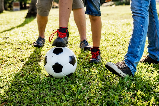 Familie, die fußball im garten spielt PremiumFoto