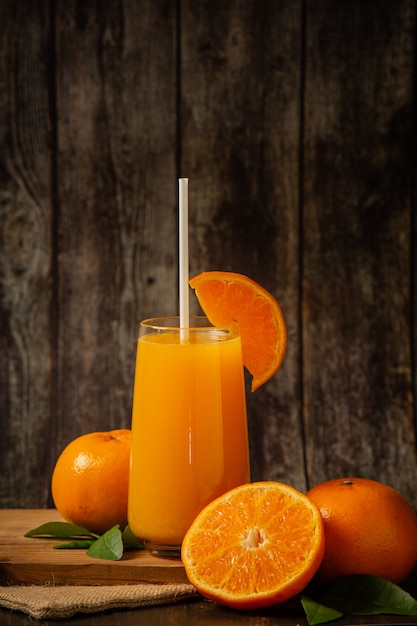 Frischer orangensaft in einem glas und frische orange | Kostenlose Foto