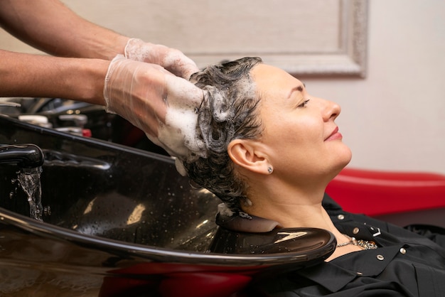 Friseur, der die haare einer frau wäscht Kostenlose Foto