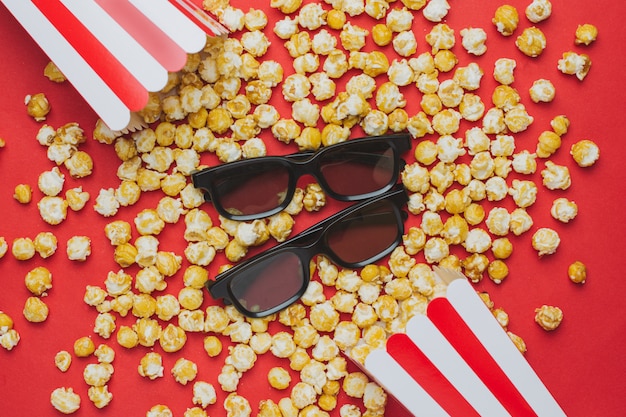 Gläser und popcorn auf roter draufsicht Premium Fotos