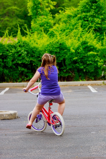 Glückliches kind auf einem fahrrad junges mädchen, das ihr