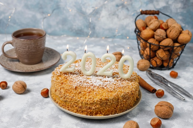Karottenkuchen mit 2020 kerzen und einer tasse tee auf grauem beton Kostenlose Fotos