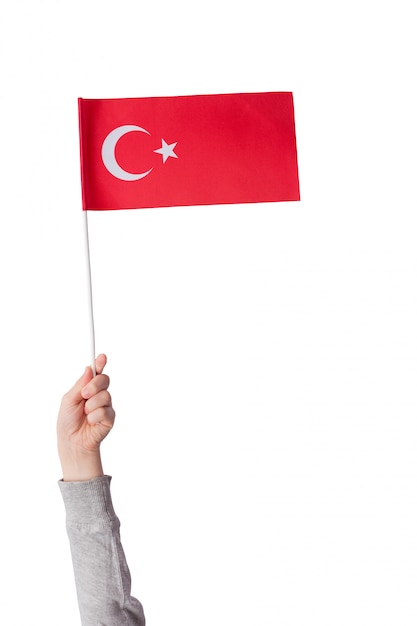 Kinderhand Halt Die Flagge Der Turkei Mond Und Stern Der Roten Fahne Vertikaler Rahmen Auf Weiss Isolieren Premium Foto