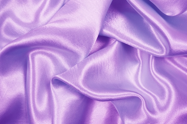 Luxusstoffbeschaffenheit des schönen purpurroten satins kann als hochzeitshintergrund, gewebe verwenden Premium Fotos