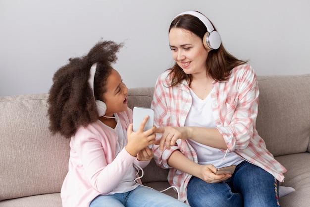 Mutter und tochter hören zu hause musik Kostenlose Foto