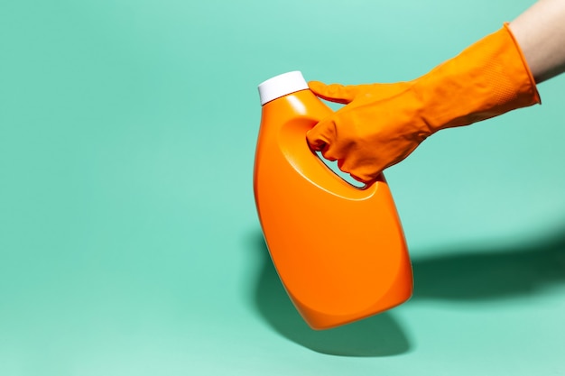 Nahaufnahme Der Weiblichen Hand Die Orange Reinigungshandschuh Tragt Waschmittelflasche Auf Wandaqua Menthe Farbe Halt Premium Foto