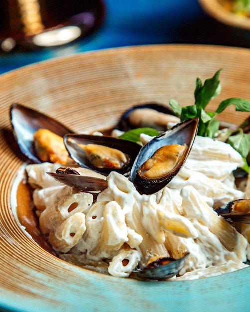 Penne pasta mit muschel minze seitenansicht | Kostenlose Foto