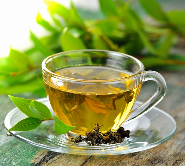 Tassen grüner tee auf tisch auf hölzernem hintergrund | Premium-Foto