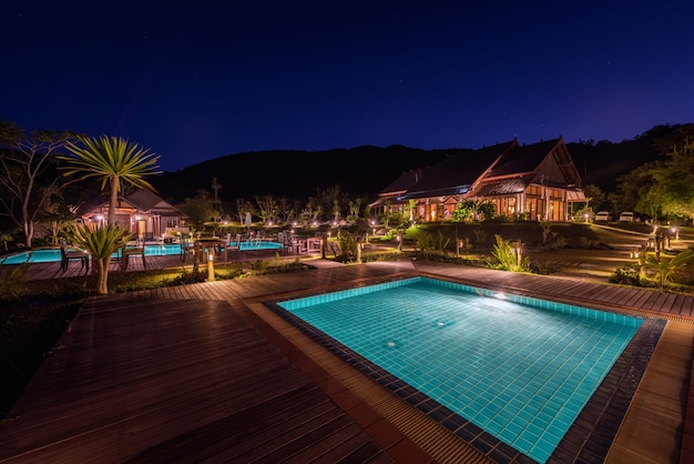  Tropisches  resort mit schwimmbad  in der nacht Premium Foto