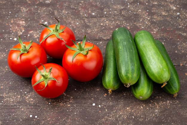 Vorderansicht frische rote tomaten reif zusammen mit grünen gurken auf