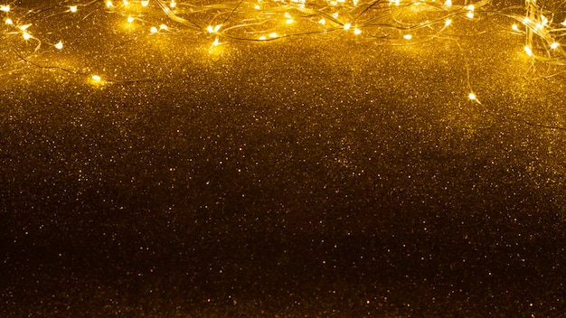 Weihnachtsbeleuchtung auf glitzer hintergrund Premium Fotos