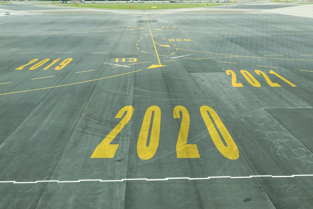 The 2020 number sign on the airport runway shows the coming new year's reception soon. Premium Photo