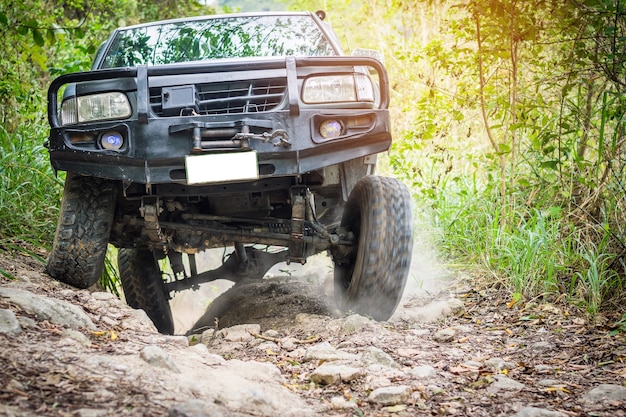 4 wheel drive is climbing on a difficult off-road in mountain forests in thailand. | Premium Photo