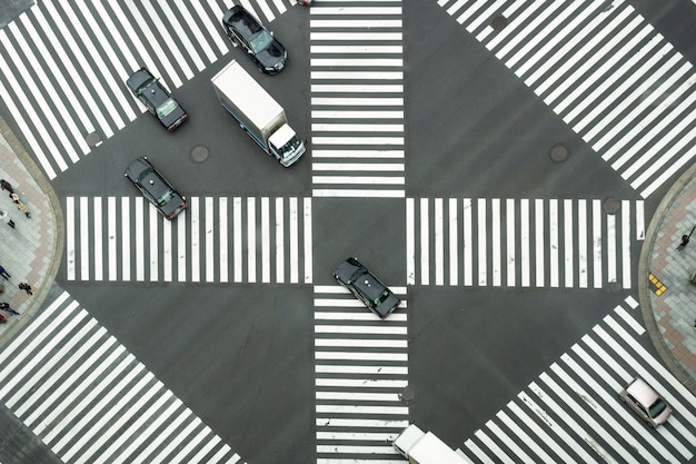 未定義の日本人の群衆の平面図は、建物の間の通りを横切るために歩いています Premium写真