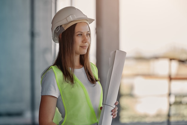 Premium Photo | Absorbed female engineer among scaffolding. portrait of ...