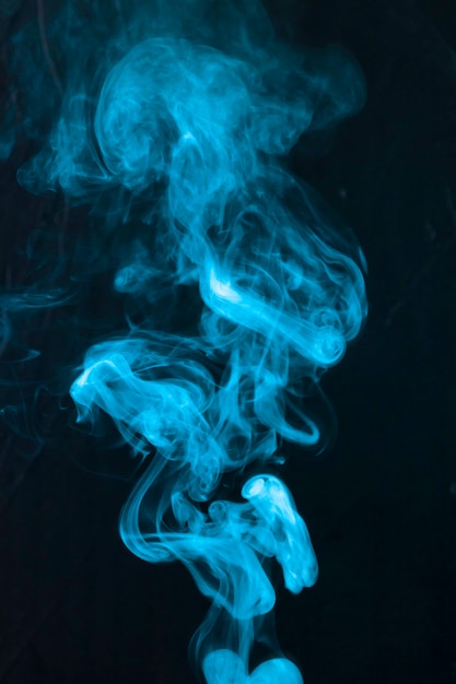 Free Photo | Abstract of blue smoke fumes moving upward on black background