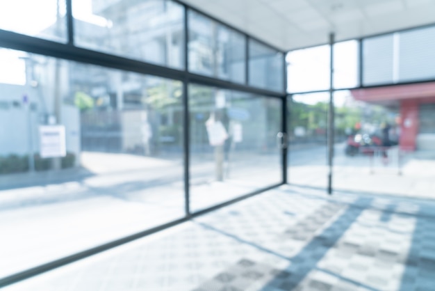 Premium Photo | Abstract blur empty office with glass window and sunlight